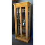 A 20th Century French Style Display Cabinet, the moulded cornice above two glazed doors enclosing