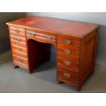 A Victorian Twin Pedestal Desk, the red tooled leather inset top above nine drawers with brass