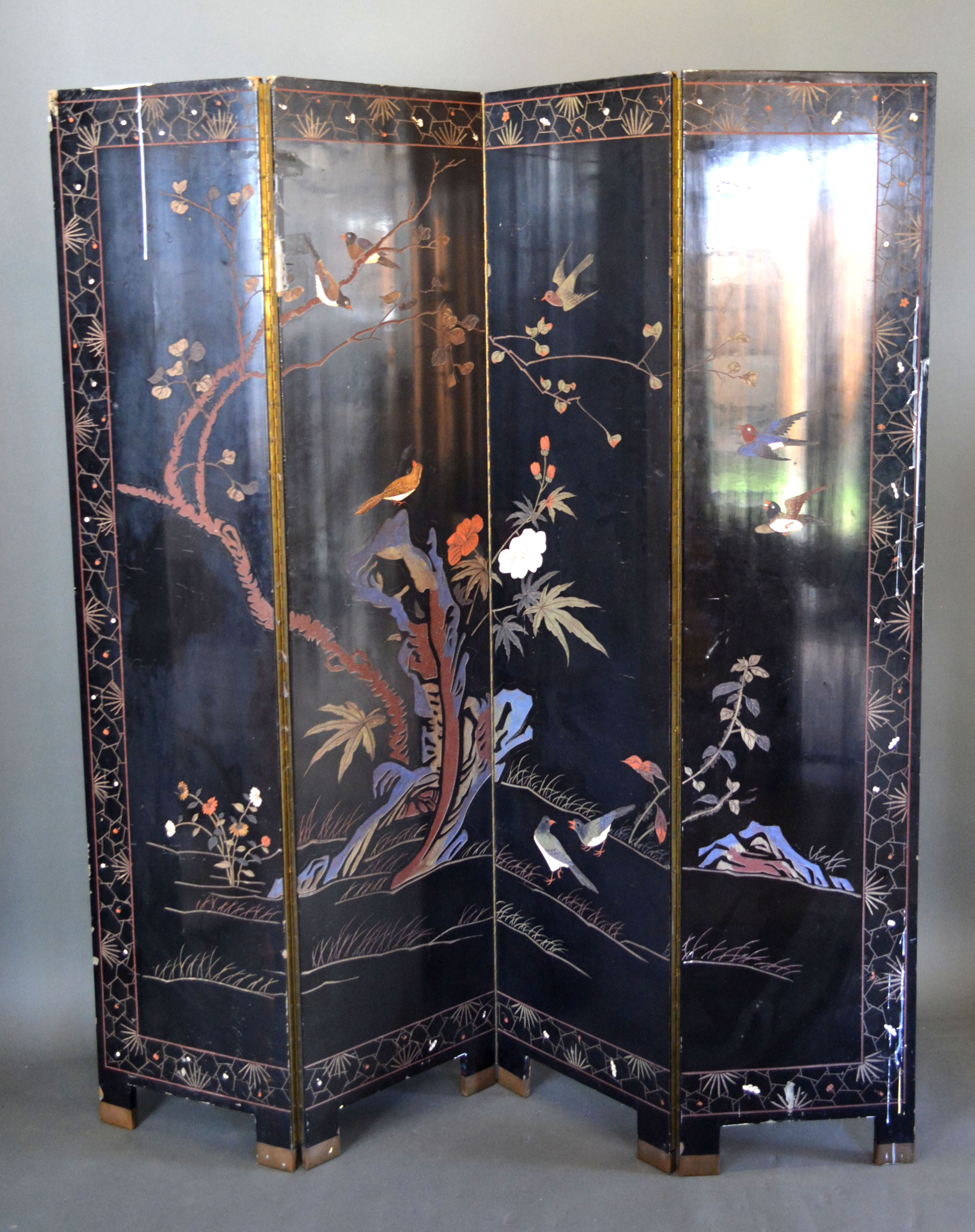 A Chinese Lacquered Four Fold Screen depicting figures within a landscape amongst buildings, the - Image 2 of 3