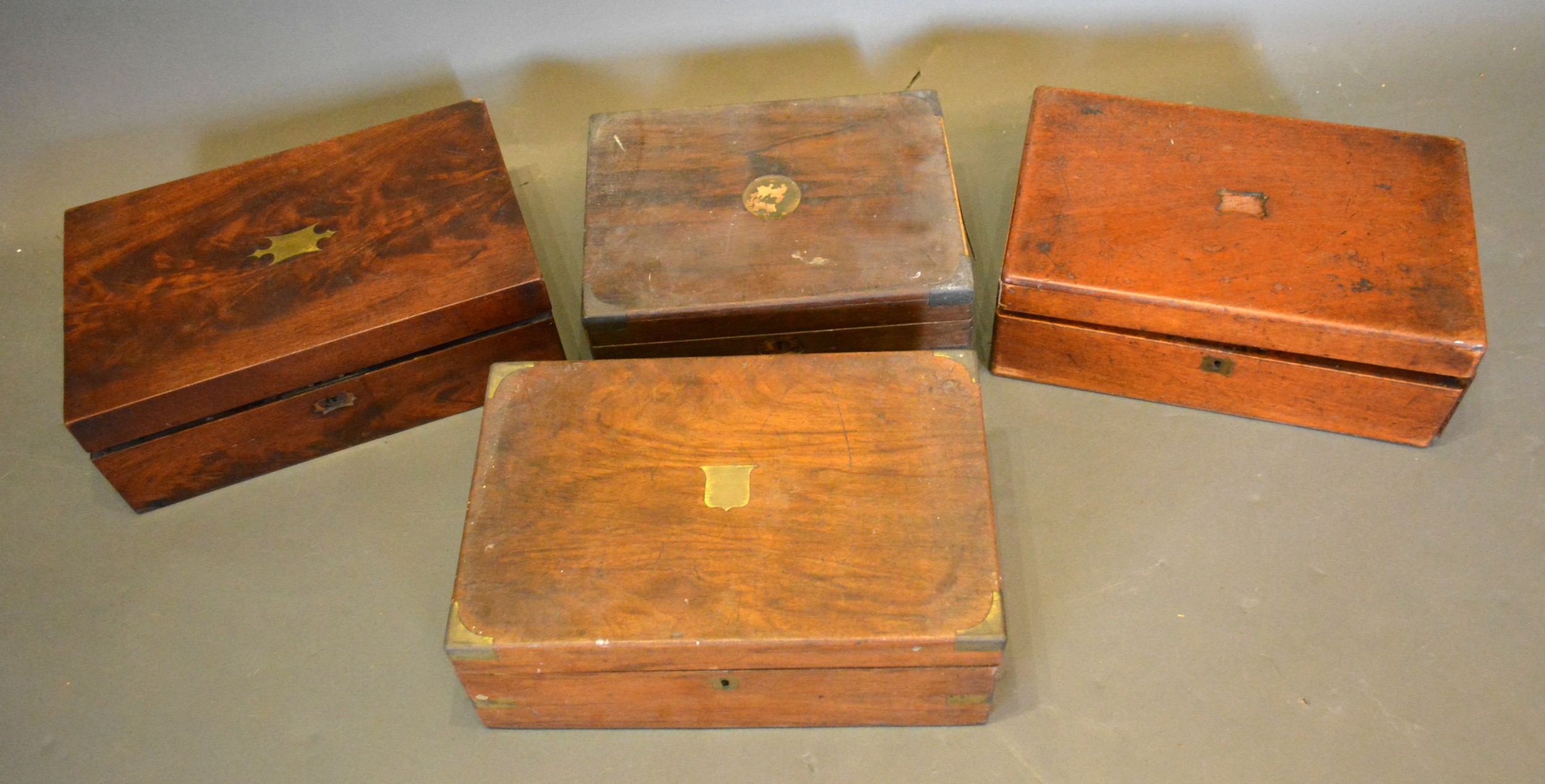 A 19th Century Mahogany and Brass Inlaid Fold Over Writing Box together with three other similar