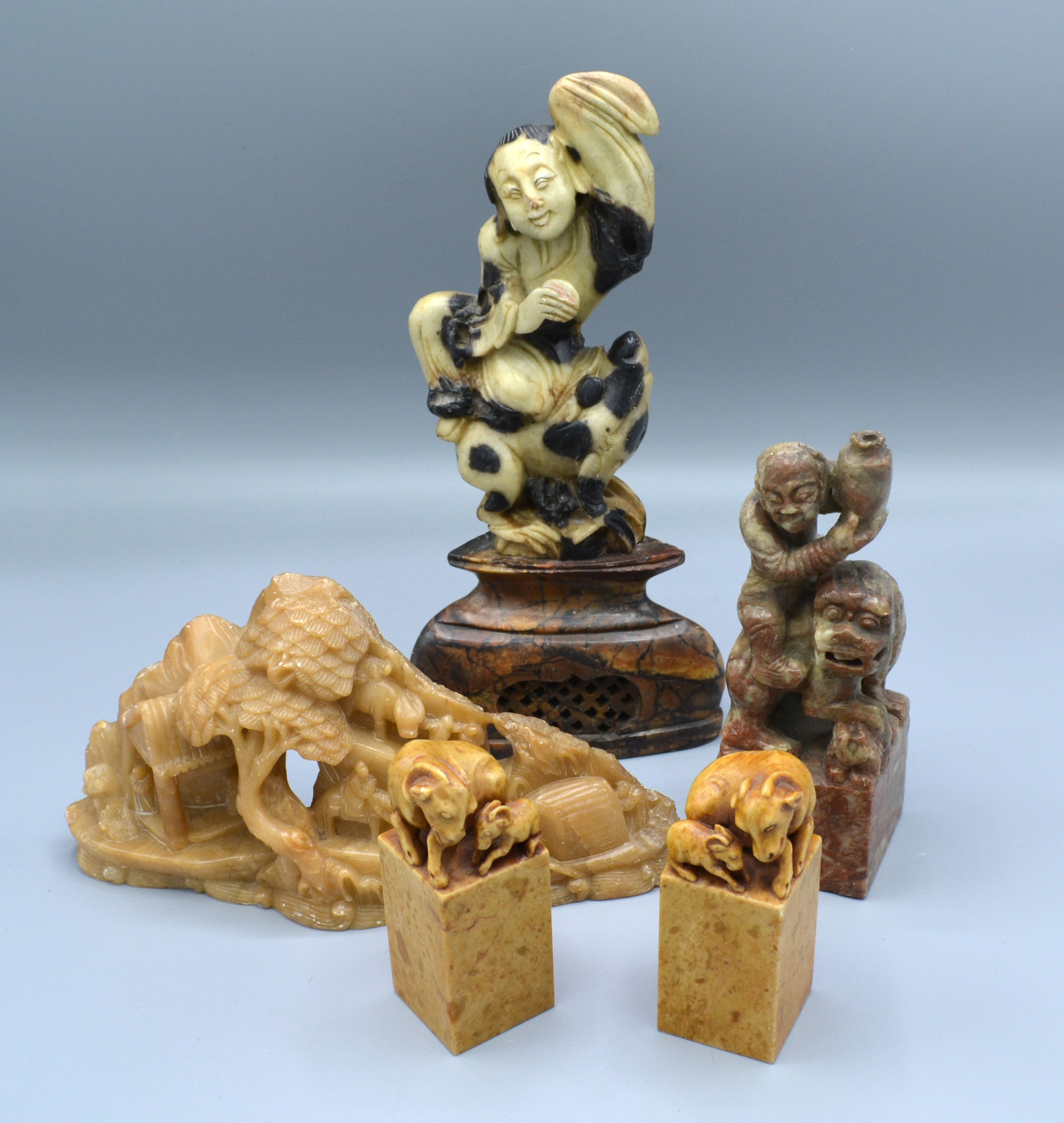 A Pair of Chinese Soapstone Models of Goats with square bases together with three other Chinese