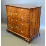 A George II Walnut Chest of two short and three long drawers with brass handles and escutcheons