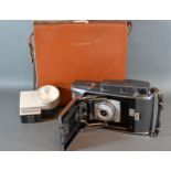 A Polaroid 120 within original leather case