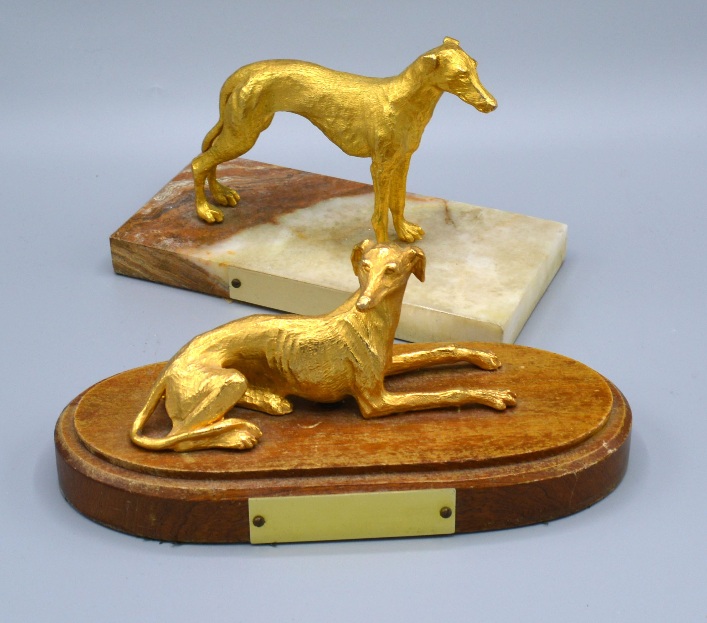 A Gold Plated Model of a Greyhound on rectangular marble plinth 11 cms high together with another