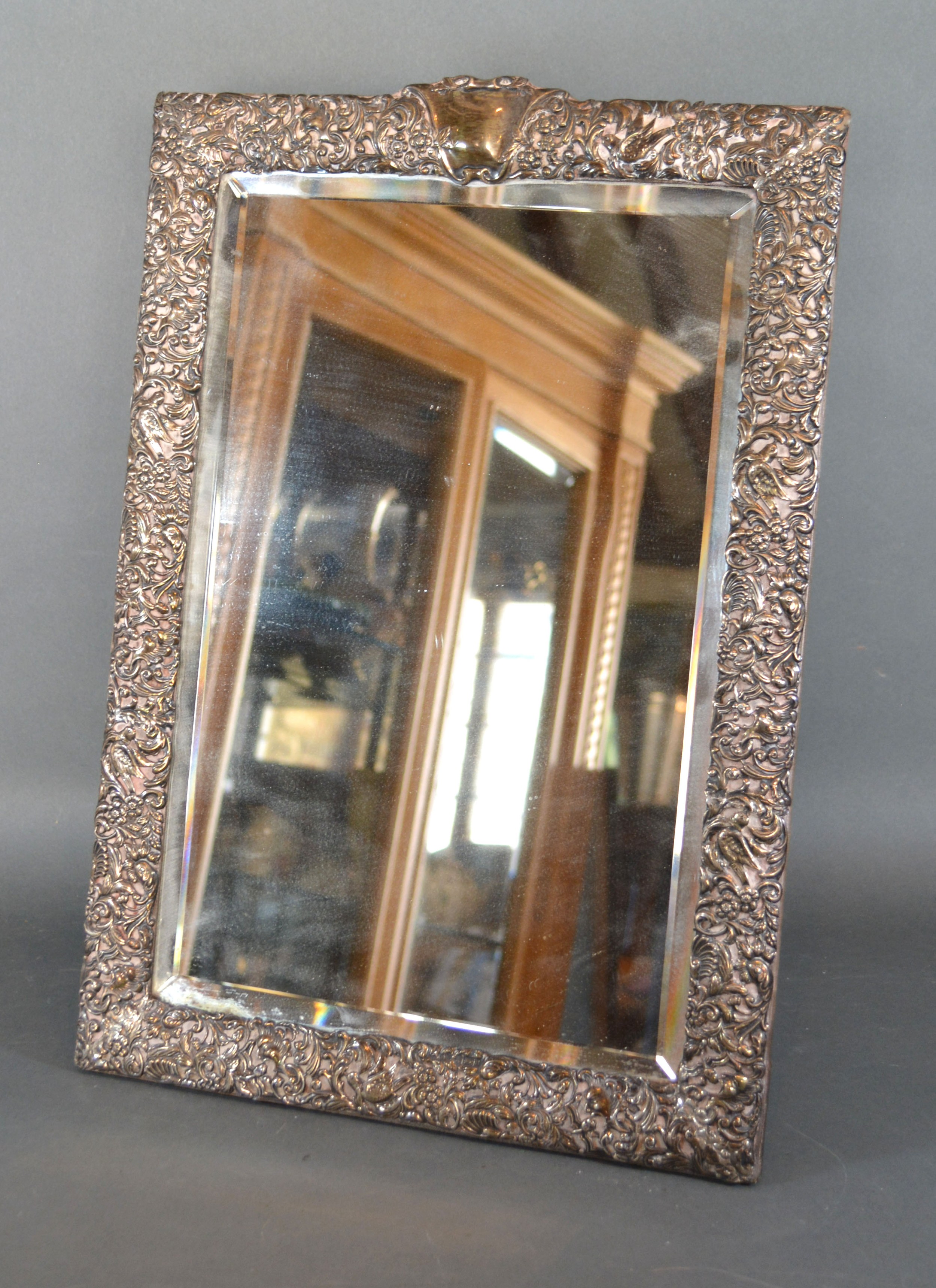 A Victorian Silver Table Mirror embossed with birds amongst foliage Birmingham 1900 46 x 32 cms