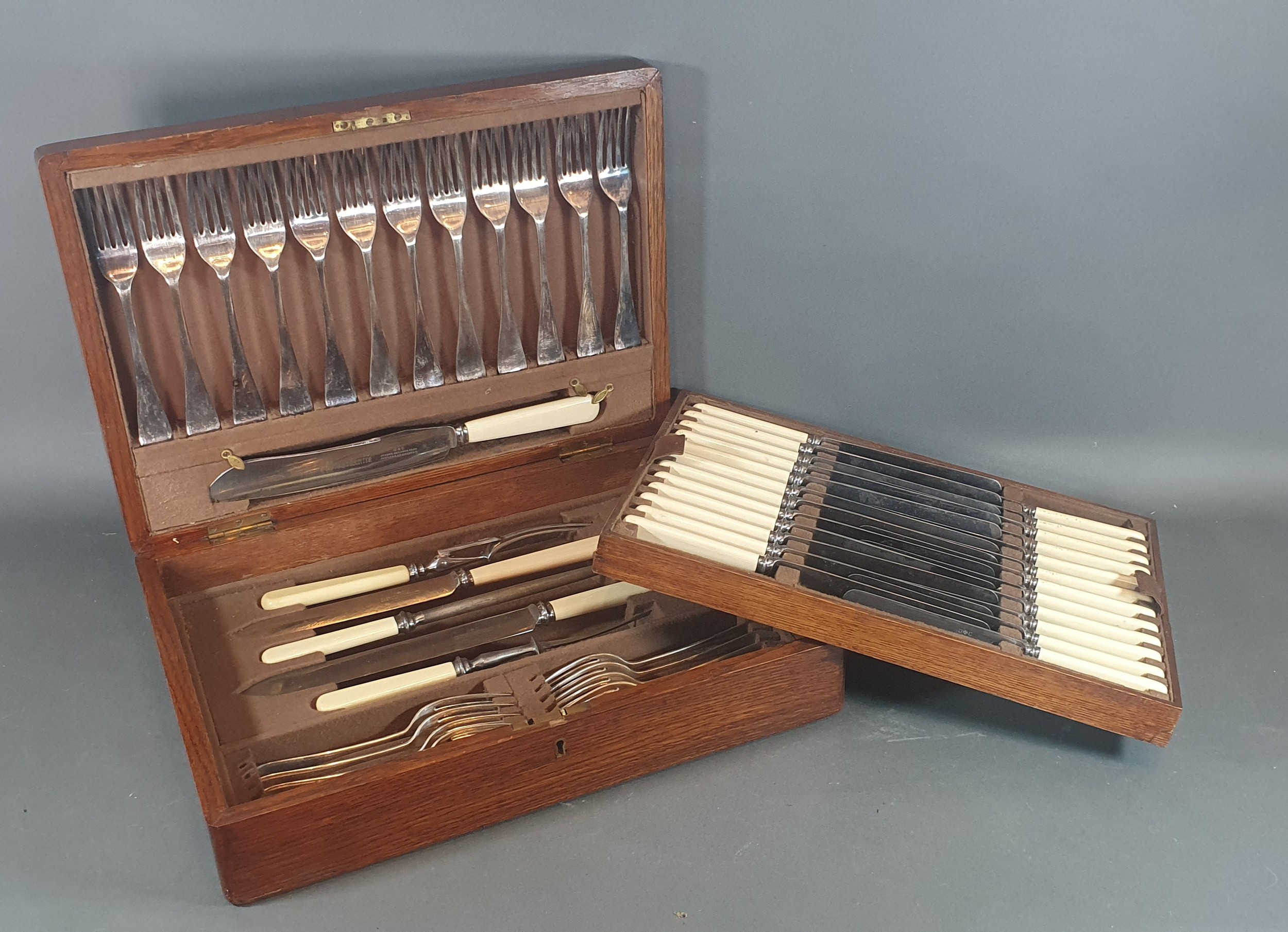 A late 19th century canteen of silver plated flatware in oak case
