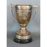 A Birmingham Silver Two Handled Trophy Cup with hardwood stand 18 ozs. 28 cms tall