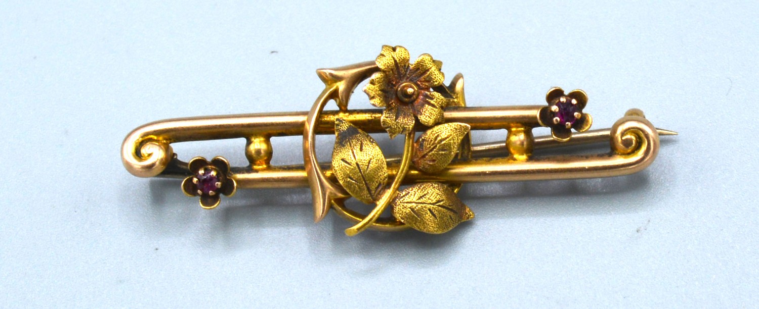 A 15ct Gold Bar Brooch of Foliate Form set with two small garnets