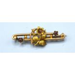 A 15ct Gold Bar Brooch of Foliate Form set with two small garnets
