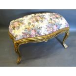 A French Style Gilded Large Stool, the upholstered top above a carved frieze raised upon cabriole