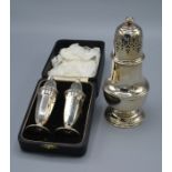 A Birmingham Silver Sugar Caster 17 cms tall together with a Sheffield silver salt and pepper within