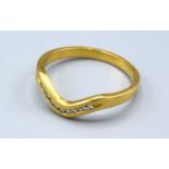 An 18ct Yellow Gold Diamond Set Ring of V Shape set with eleven diamonds, 4 gms Size U
