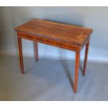 A 19th century mahogany rectangular card table, the hinged top above a frieze drawer raised upon