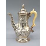 A George III Silver Coffee Pot with shaped handle and circular pedestal base Newcastle 1760-1768