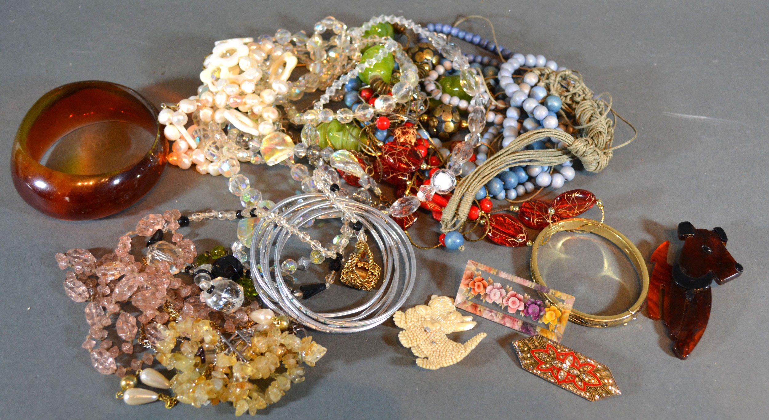 A Collection of Jewellery to include bead necklaces, brooches, bangles and other items