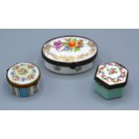A French Porcelain Pill Box of oval form hand painted with summer flowers and highlighted with