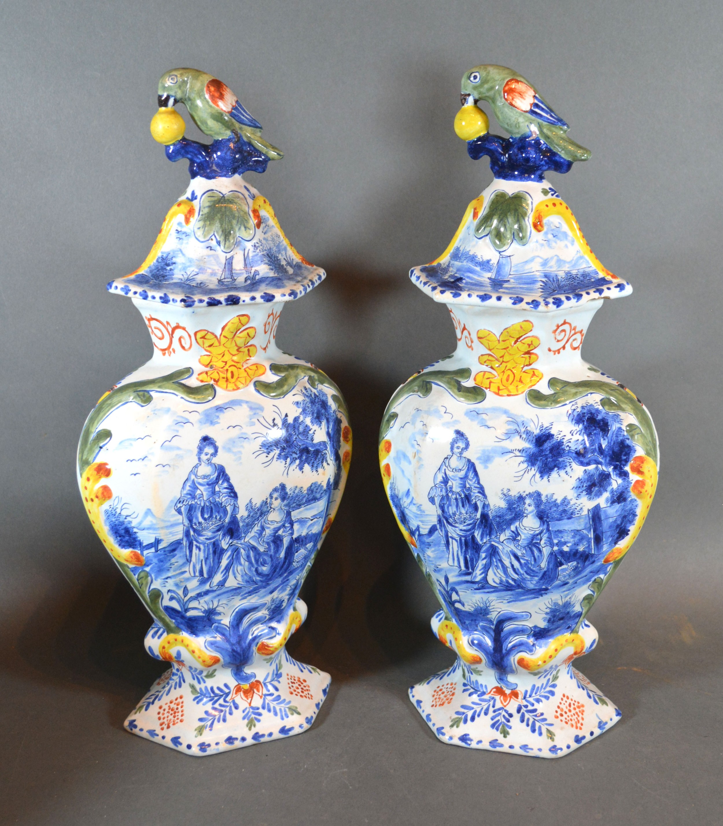 A Pair of Delft Covered Vases each with bird surmount decorated in underglaze blue and polychrome