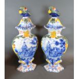 A Pair of Delft Covered Vases each with bird surmount decorated in underglaze blue and polychrome