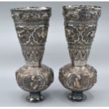 A Pair of Indian White Metal Spill Vases decorated in relief with figures and birds 19 cms tall