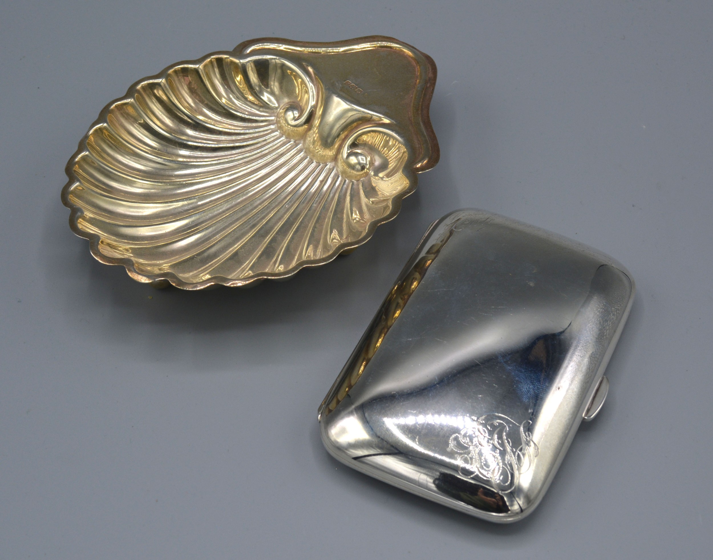 A Sheffield Silver Cigarette Case of curved form together with a Sheffield silver butter dish of