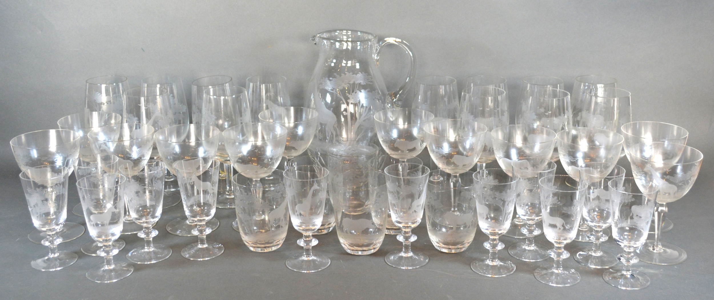 A Moser Rowland Ward Safari Pattern Cut Glass Drinking Set comprising a large jug, wine glasses,