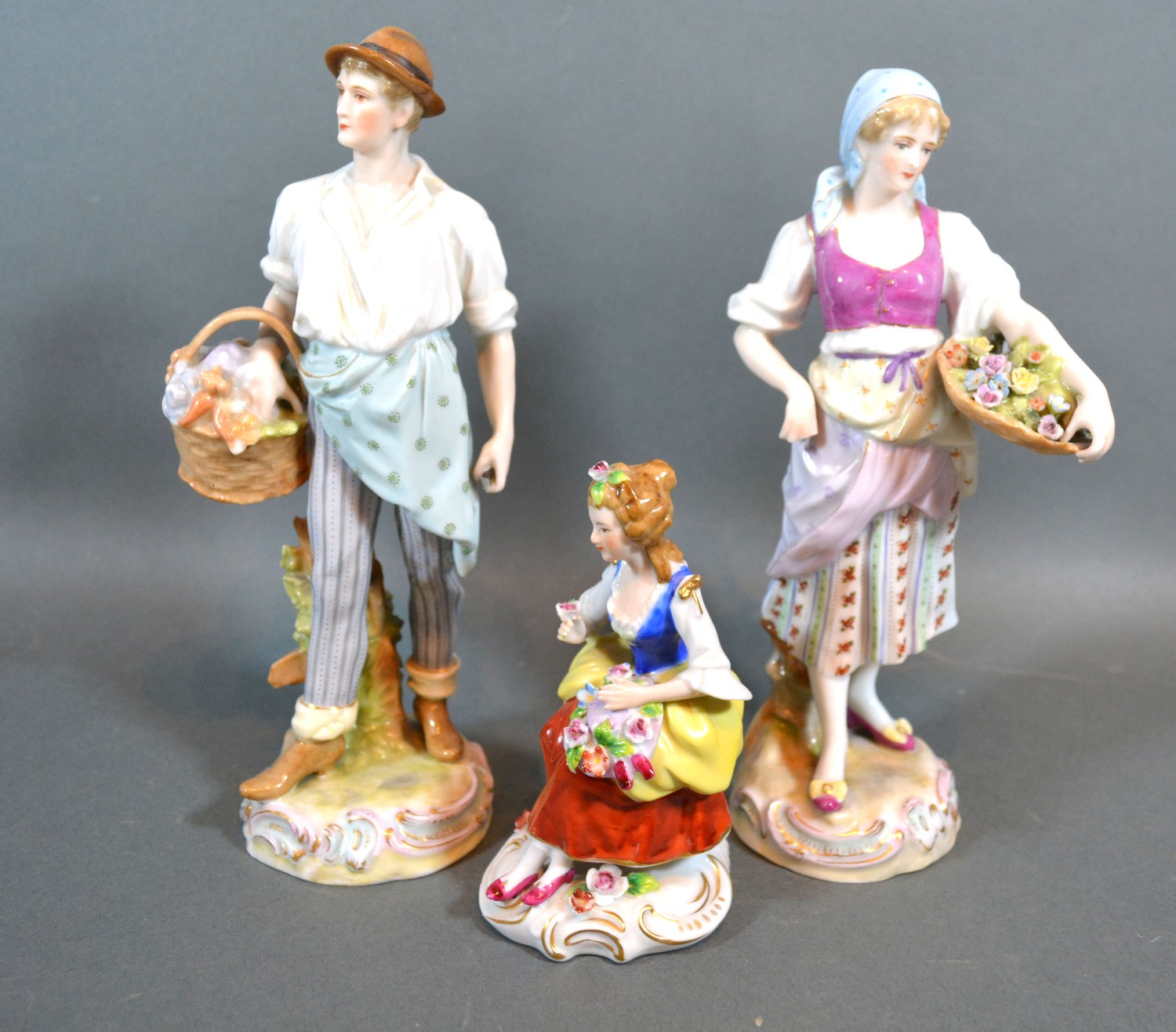 A Pair of Late 19th century German porcelain figures "The Flower Sellers" 22cm tall together with