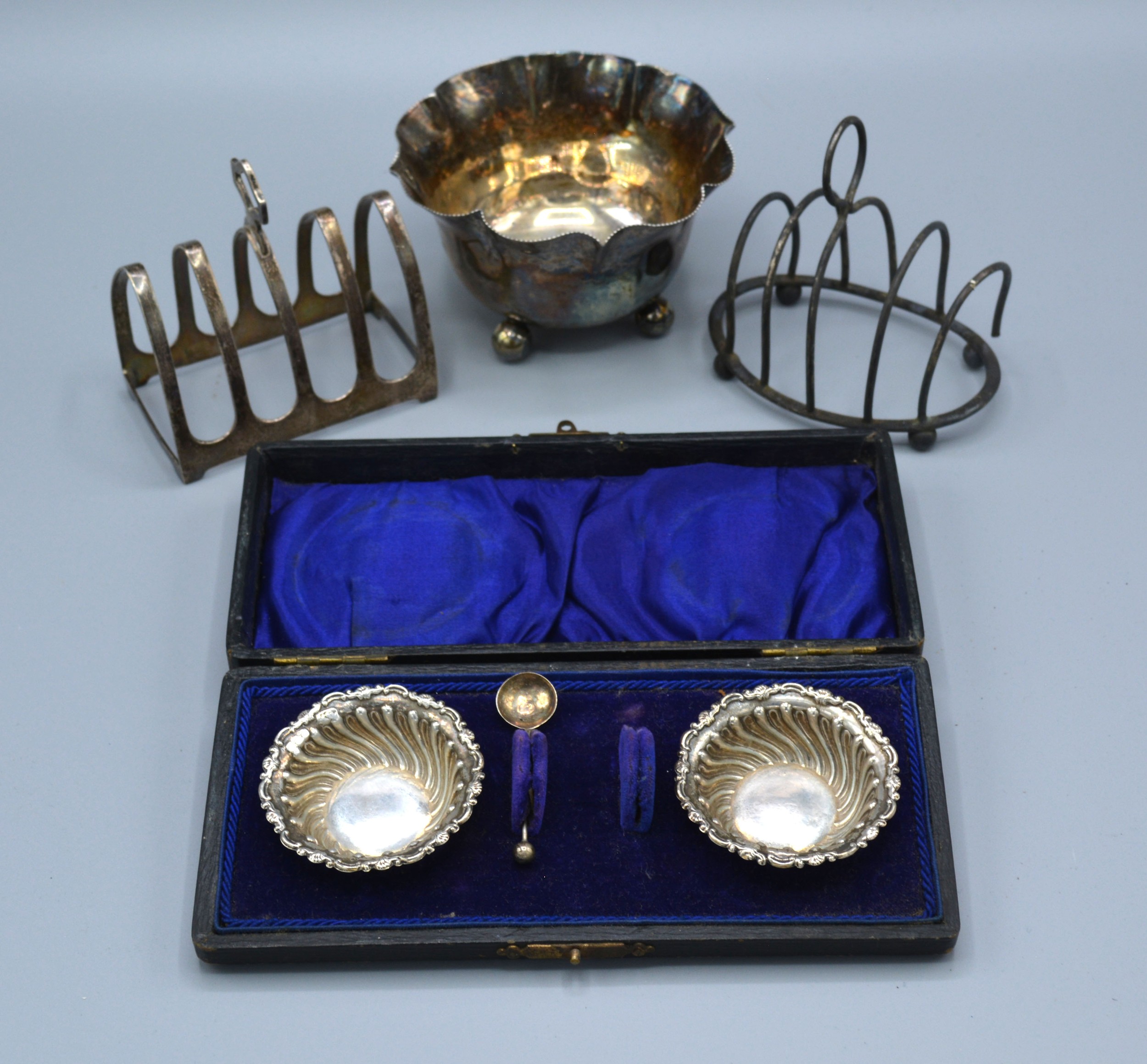 A London Silver Sugar Bowl together with two silver four division toast racks and a pair of