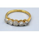 An 18ct. Gold and Platinum Five Stone Diamond Ring with five stones within a pierced setting, ring