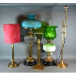 A Victorian Brass Oil Lamp with clear glass well and opaque glass shade together with another