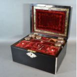 A 19th Century Ebonised and Mother of Pearl Inlaid Dressing Case, the hinged cover enclosing a