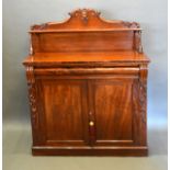 A Victorian Mahogany Chiffonier, the shaped back above a concealed frieze drawer and two panel doors