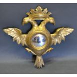 A 19th Century Giltwood Convex Wall Mirror in the form of a double eagle with crown cresting 57 x 61