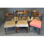 A Set of Three Regency Mahogany Dining Chairs each with a reeded rail back above a stuff over seat