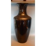 A Black Glass Floor Vase of Oviform 77 cms tall