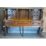 A 19th Century Oak Dresser, the carved back with turned uprights, the lower section with three