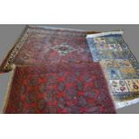 A North West Persian Woollen Rug with a central medallion within an all over design upon a red, blue