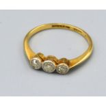An 18ct. Gold Three Stone Diamond Ring, size O, 2.1 gms.