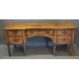 A George IV Mahogany Inverted Sideboard with five drawers and oval brass handles raised upon
