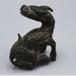 A Chinese Patinated Bronze Dog of Fo 7 cms tall
