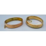 A 9ct. Gold Engraved Bangle together with another similar plain 9ct. gold bangle, 30.5 gms.