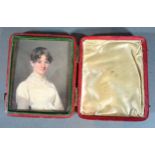 A 19th Century Portrait Miniature in the form of a girl in period dress within leather folding case,