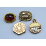 A George IV mourning brooch set seed pearls together with a cabouchon stone set small brooch, a