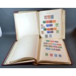 A Stanley Gibbons New Age Stamp Album containing world stamps, mint and used, in two albums