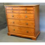 An Arts and Crafts Pitch Pine Chest with four small drawers above three graduated drawers with brass