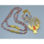 A Pendant in the form of an Eagle by Accessocraft together with another similar, both with chains,