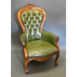A Victorian Style Armchair with a green leather buttoned back and seat raised upon cabriole legs