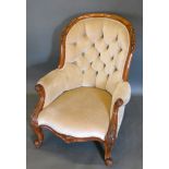 A Victorian Walnut Drawing Room Armchair, the partly carved and button upholstered back with