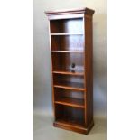 A Mahogany Tall Narrow Bookcase with a moulded cornice above open shelves raised upon a plinth, 66