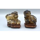 A Pair of late 19th Chinese Rock Crystal Models in the form of Foe Dogs, each with a hardwood