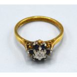 An 18ct. Gold Diamond and Sapphire Cluster Ring, ring size O, 3.5 gms.